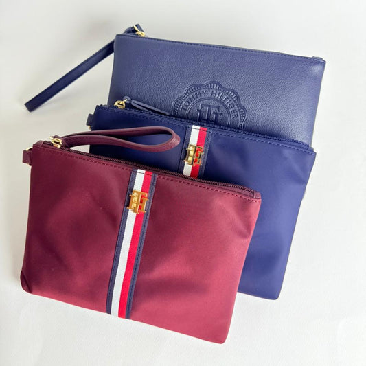 3 bags, 2 blue and one red with a Tommy Hilfiger logo