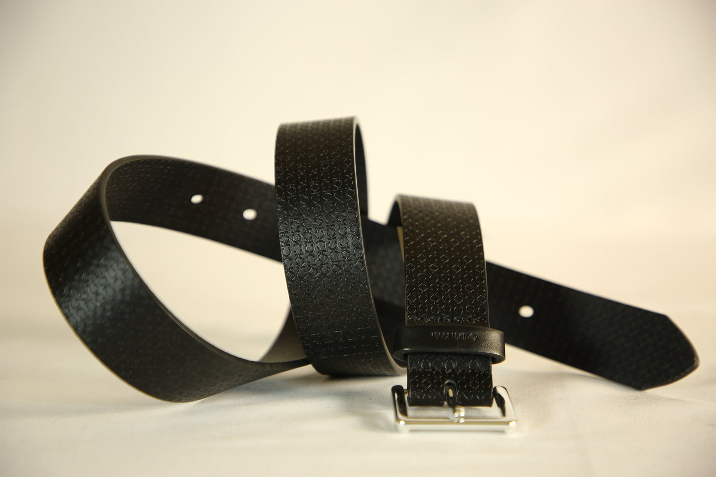 Calvin Klein Monogram Engrave Leather Belt with a silver buckle