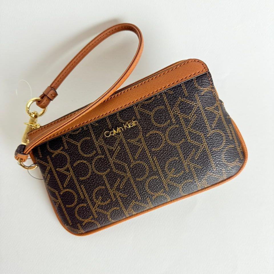 A Brown Calvin Klein wallet with gold logo pattern