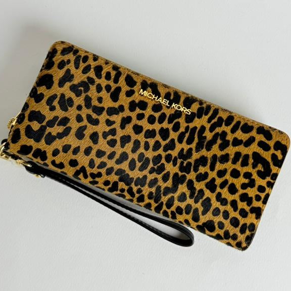 Leopard print wallet with 'Michael Kors' branding 