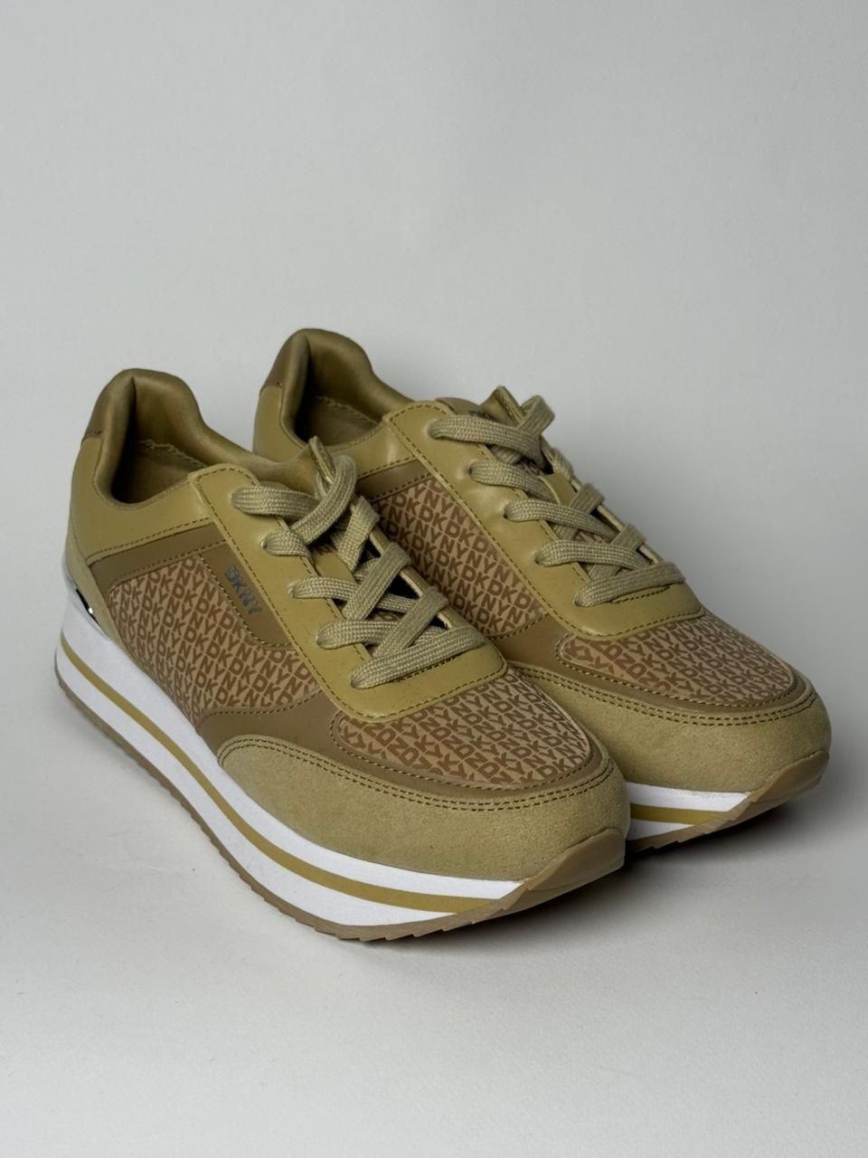 DKNY monogram wedge sneakers in a tan/beige color.