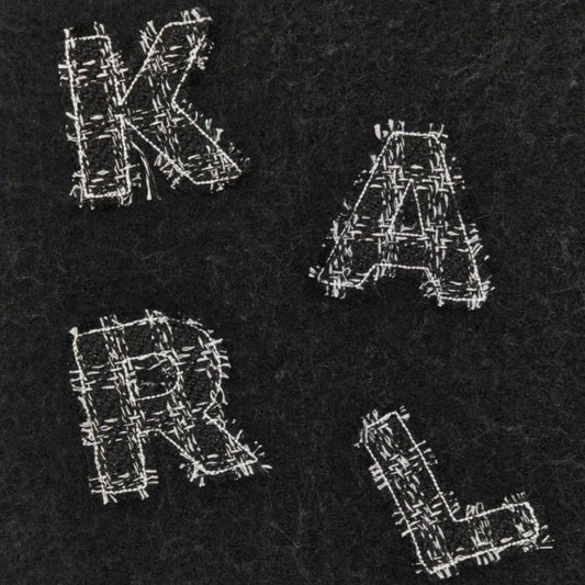 Close-up of Karl Lagerfeld scarf showing embroidered 'KARL' letters on dark wool fabric