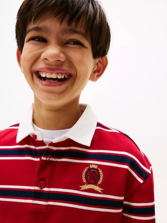 Child wearing a red striped polo Tommy Hilfiger shirt
