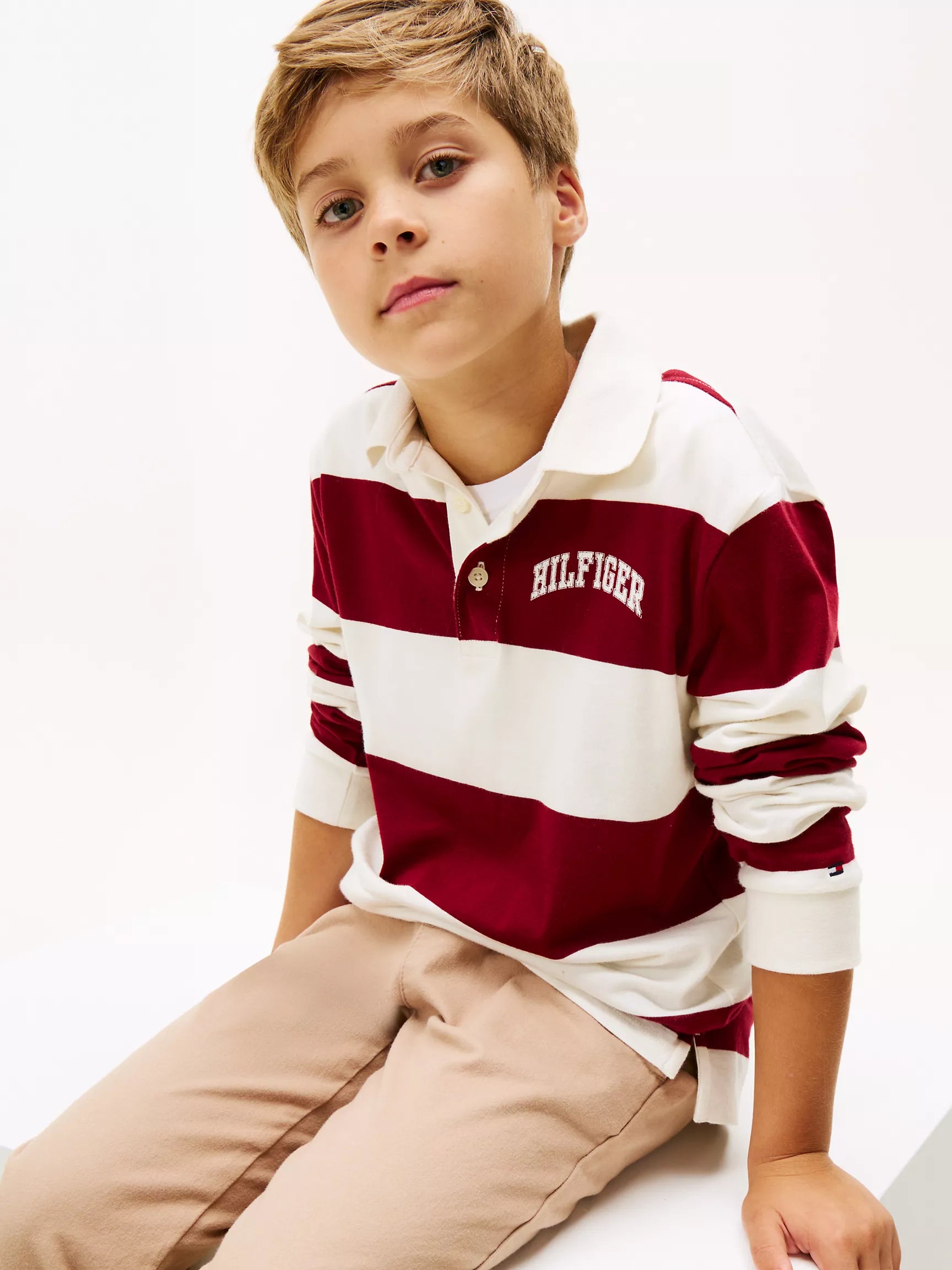 Child wearing a Tommy Hilfiger striped polo shirt