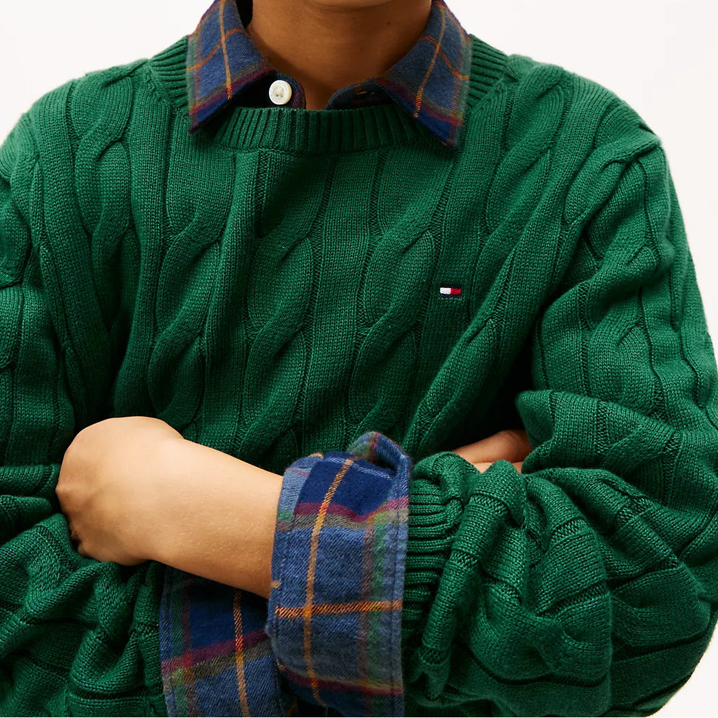 Child wearing a Tommy Hilfiger green sweater